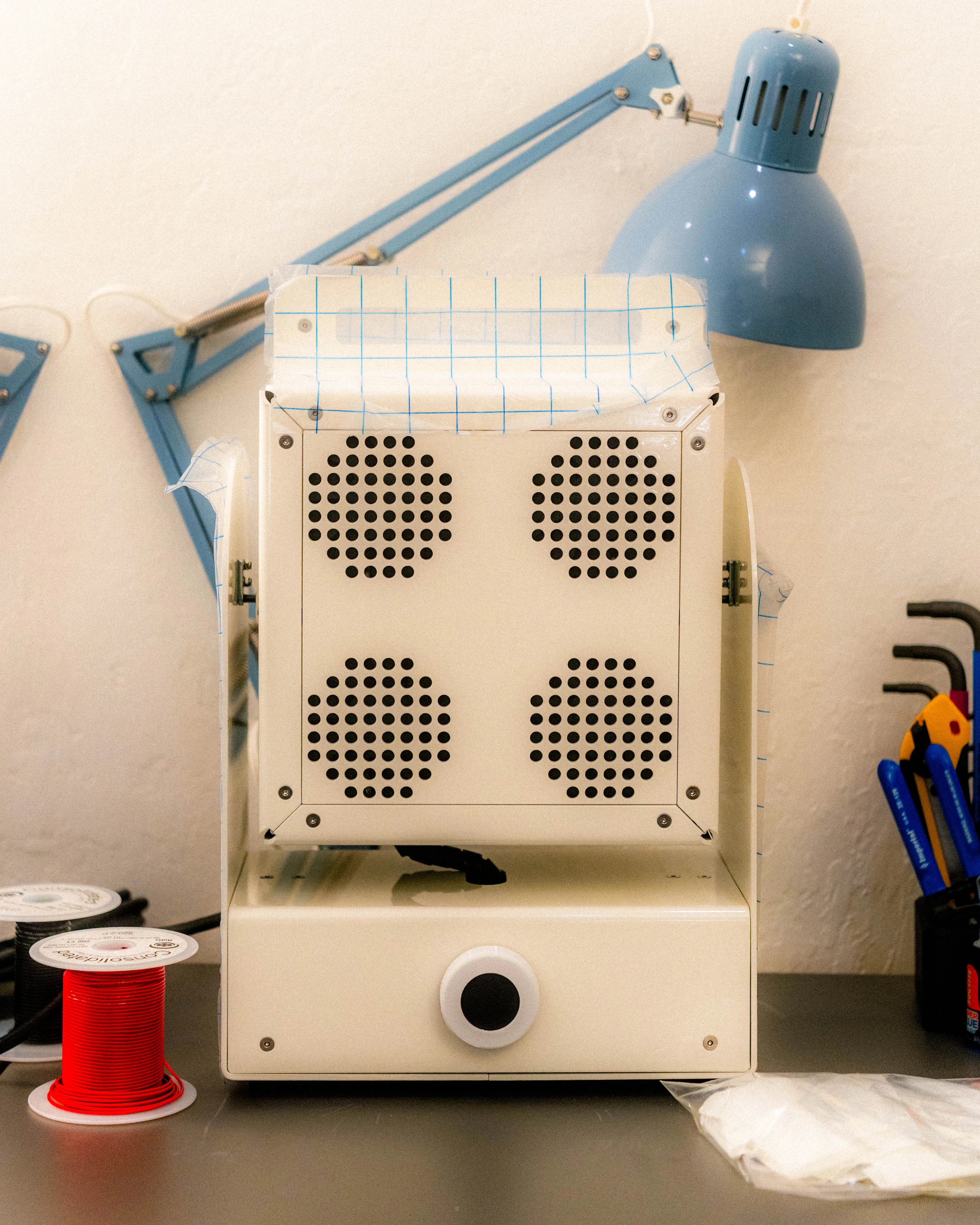 An assembled Sunlight Generator beside a work lamp on the bench